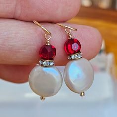 I have combined cream-colored Freshwater coin pearls with small red faceted glass crystal beads that sparkle in the light. These pretty earrings also feature Swarovski crystal rondelles.  All wire wrapped and finished with gold-filled ear wires. These delightful earrings are delicate and feminine.  Price:$22.00 Earring length: 1 3/8 inches long from the top of the ear wire to the bottom of the earring.  Uniquely packaged, your earrings will arrive safely and tucked into a complimentary gift box Red Pearl Drop Earrings, Wire Wrapped Jewelry Diy, Burlington Vt, Coin Pearls, Wrapped Jewelry, Pretty Earrings, Faceted Glass, Glass Crystal, How To Make Earrings