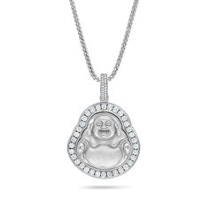 a pendant with a buddha face on it's side and diamonds around the edges