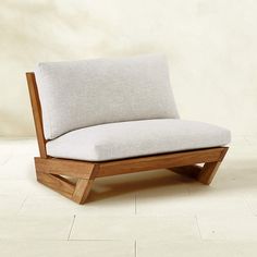 a wooden chair sitting on top of a white tile floor