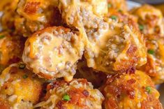 a plate full of meatballs covered in cheese