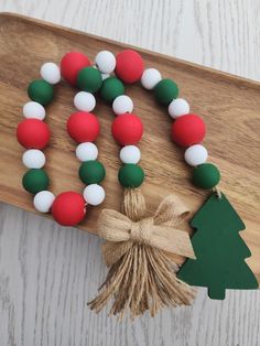 a wooden board with christmas decorations on it and a tree decoration hanging from the side