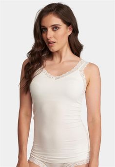 Fleur't's Lace Strap Camisole is the perfect go-to layering piece. Soft and subtle, this cami can be worn underneath most tops, blouses and knits - yet covered enough to be worn on hot summer days and nights. Made of cloud-soft, eco-friendly fabric and edged with 1 inch delicate stretch lace.  Features: •Mid-length hits right below hips • Eco-friendly, cloud-soft TENCEL™ Modal x Eco Soft technology fabric •Curved V-neck and double lace strap for soft, feminine appeal •Built-in “no-show” shelf bra for coverage and support  Designed by women. Sustainably sourced and ethically made.  Main Fabric: 94% TENCEL™ Modal x Eco Soft technology, 6% Spandex.  Care Instructions •Hand wash OR machine wash cold in mesh bag on gentle cycle •Lay flat to dry  Style #610 Loungewear Capsule, Oxford Blue, Lace Straps, Lace Camisole, Eco Friendly Fabric, Feminine Look, Shelf Bra, Stretch Lace, Hot Summer