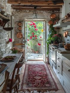 an open door leading to a kitchen with flowers on the wall and potted plants