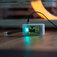 an electronic device sitting on top of a wooden table