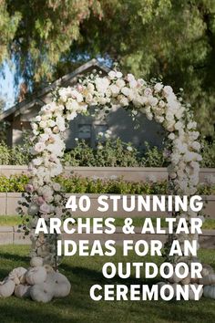 an arch decorated with white flowers and greenery in front of a wooden bench that reads 40 stunning arches & altar ideas for an outdoor ceremony