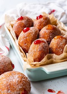 there are several pastries in a tray on the table with words above it that say, these are proper yeasted fried doughnuts