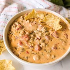 a white bowl filled with salsa and tortilla chips on top of a table