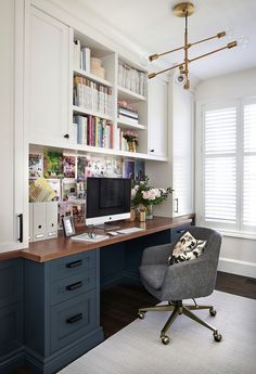 a home office with built in bookshelves and desk