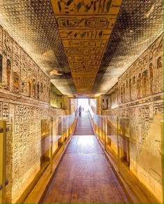 the inside of an egyptian temple with many paintings on the walls