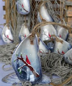 some glass ornaments are sitting on rope and burlied with twine nets,