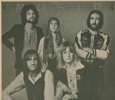 an old black and white photo of four people with long hair, wearing vests