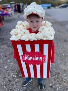 a young boy in a popcorn box costume