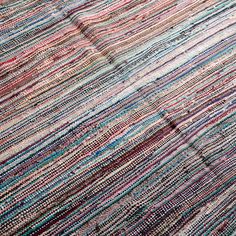 a multicolored rug is laying on the floor