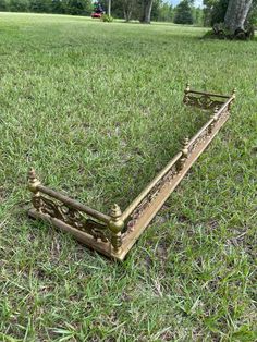 an old bed frame laying in the grass