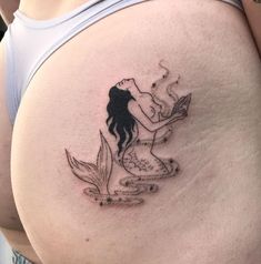 a woman with a tattoo on her stomach