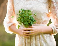 a woman holding a plant in her hands