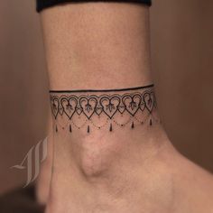 a woman's ankle tattoo with hearts and arrows on the side of her foot