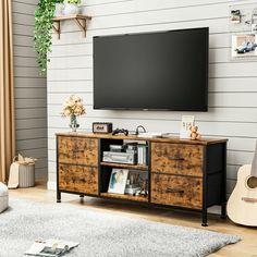 a flat screen tv mounted to the side of a wooden entertainment center in a living room