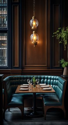 a restaurant booth with green leather booths and wooden tables in front of large windows that have glass globes hanging from the ceiling