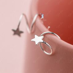 These gorgeous, delicate star hoop earrings are crafted from pure 925 sterling silver and feature a polished finish for a stunning shine. The intricate spiral design ensures that they are comfortable for daily wear and can easily elevate any outfit. Add these charming star spiral hoops to your everyday collection or gift them to a loved one. Materials: 925 sterling silverFinish: gold plate, platinum plate Jewelry Care: See more information about how to care for your jewelry here. Shipping Policy Ear Huggies, Star Hoop Earrings, Plate Jewelry, Silver Jewelry Earrings, Handmade Fashion Jewelry, Spiral Design, Fine Jewelry Collection, Everyday Earrings, Screw Back Earrings