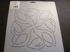 a white cutting board with an image of leaves on the front and back side, cut out to be used as a stencil