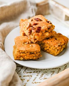 three pieces of carrot cake on a white plate