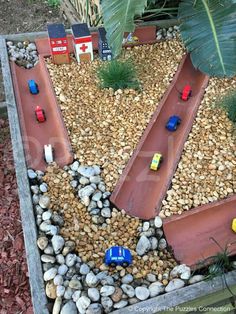 toy cars are lined up on the rocks in this miniature track set made out of legos