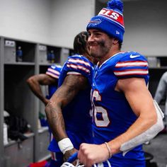 two football players in the locker room