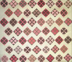 an old quilt with pink and brown squares on it's sides, in the shape of diamonds