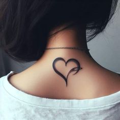 a woman's back neck with a heart shaped tattoo on the upper part of her neck