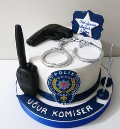 a police cake with handcuffs and keys on it's side, as well as a pair of scissors