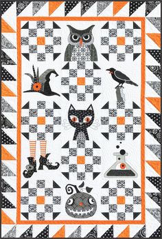 an orange and black quilt with cats on it