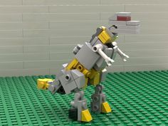 a lego robot is standing in front of a wall