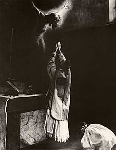 an old black and white photo of two people praying