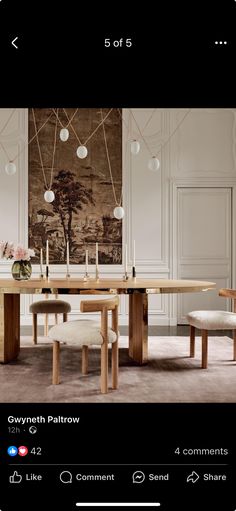 an image of a dining room with chairs and a table in front of a painting