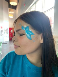 Near eye face painting of a flower Face Paint Birthday Party Ideas, Easy Things To Face Paint, Simple Flower Face Paint, Preppy Face Paint Ideas, Quick And Easy Face Painting For Kids, Super Easy Face Paint, Easy Face Painting For Beginners, Drawing On Face For Kids, Luau Face Painting Ideas