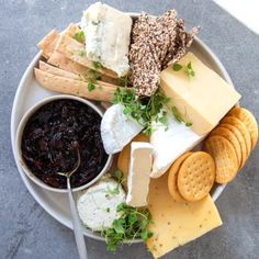 a white plate topped with lots of cheese and crackers