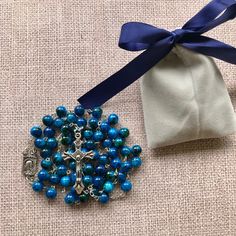 "Catholic Rosary Beads Necklace. Made and blessed in Jerusalem Holy Land Bead color: navy / multicolor Cross color - silver tone Drop length - Approximately 22\"-22.4\" ( 56-57 cm ). Approximate crucifix size -1.75\"x1\" Comes in a pouch as pictured. Silver tone metal Catholic Crucifix Cross with beautiful double sided center piece. If you have any questions, feel free to ask us. We are based in Florida and ship packages every business day very Fast and absolutely FREE! God Bless You and Your Fa Blue Beaded Rosary As A Gift, Adjustable Blue Beaded Rosary, Blue Rosary With Round Beads For Gift, Adjustable Blue Rosary With 8mm Beads, Beaded Rosary With Oval Beads As Gift, Spiritual Blue Rosary With 108 Beads, Gift Beaded Rosary, Blue 108 Beads Spiritual Rosary, Blue Spiritual Beads With Colorful Details