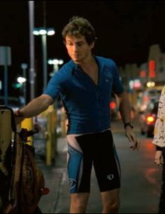 two men walking down the street at night