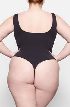 Built for everyday lightweight smoothing and support, this bodysuit features a seamless thong back and a scoop neck that's invisible under clothes. Plus, it's from Kim Kardashian's highly sought-after SKIMS line. Lined gusset 85% nylon, 15% elastane Hand wash, line dry Imported Sleek Second-skin Bodysuit With Scoop Back, Smoothing Second-skin High-cut Bodysuit, Shapewear Leotard With Built-in Bra And Minimal Stretch, High Cut Seamless Bodysuit With Minimal Stretch, Minimal Stretch Shapewear Leotard With Built-in Bra, Seamless High Cut Bodysuit With Minimal Stretch, Sleek Bodysuit With Scoop Back And Moderate Coverage, Sleek Second-skin Bodysuit With Low Back, Sleek Smoothing High Cut Bodysuit