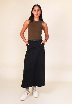 Gramicci voyager skirt - black     when you wear something by gramicci you're putting on over 30 years of innovation experience and industry leadership.    sizing: regular - shop to size  materials: 100% cotton    extra small = womens 6-8  small = womens 8-10  medium = womens 10-12  large = womens 12-14    - midi length  - slightly stretchy cotton twill fabric  - zip fly  - side pockets  - slightly flared a-line shape  - adjustable integrated belt  - nice structured fit    sinead is 175cm and ha Black Cotton Utility Skirt, Black Cotton Maxi Skirt Relaxed Fit, Fitted Black Cotton Maxi Skirt, Stepney Workers Club, Denim Sneakers, Twill Fabric, Cotton Twill Fabric, Skirt Black, Designer Outfits Woman