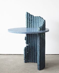 a table that has been made out of corrugated paper and is sitting on the floor