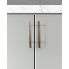 two gold handles on the side of a gray cabinet with marble counter top and bottom