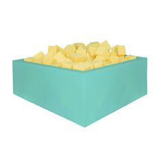 a blue box filled with lots of yellow cubes on top of each other in front of a white background