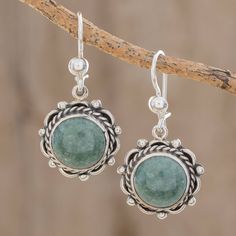 Resembling the sun as it rises over Antigua Guatemala round cabochons of apple green jade are framed by sterling silver patterns in a lovely pair of dangle earrings. The renowned Jimenez Family creates the earrings. Round Jade Jewelry With Matching Earrings, Bohemian Round Jade Jewelry, Nickel-free Round Jade Earrings, Nickel-free Round Jade Jewelry, Elegant Round Aventurine Jewelry, Bohemian Round Aventurine Jewelry, Elegant Green Circular Earrings, Bohemian Round Jade Earrings, Aventurine Round Jewelry For May Birthstone