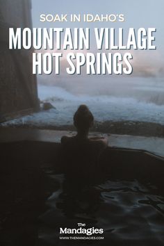 a person sitting in a hot tub with the words mountain village hot springs on it