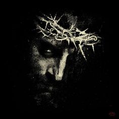 a black and white photo of a man wearing a crown of thorns on his head