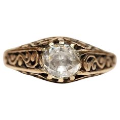 an old fashioned ring with a white diamond