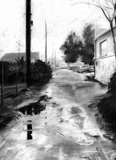 a black and white photo of a street with water on the ground in front of it