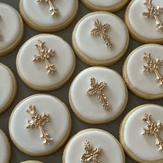 many decorated cookies with gold crosses on them